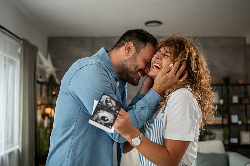Young couple expecting a baby, first moments of joy