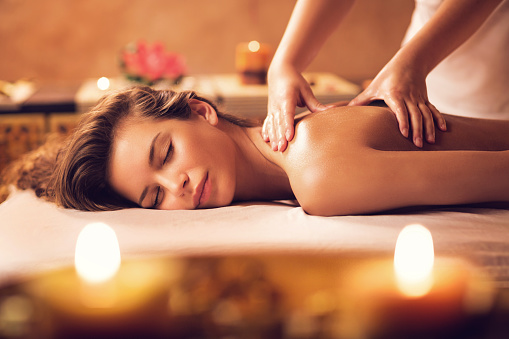 Young woman relaxing during back massage at the spa